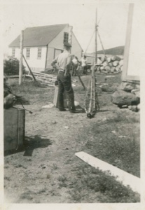 Image of Men standing near small building